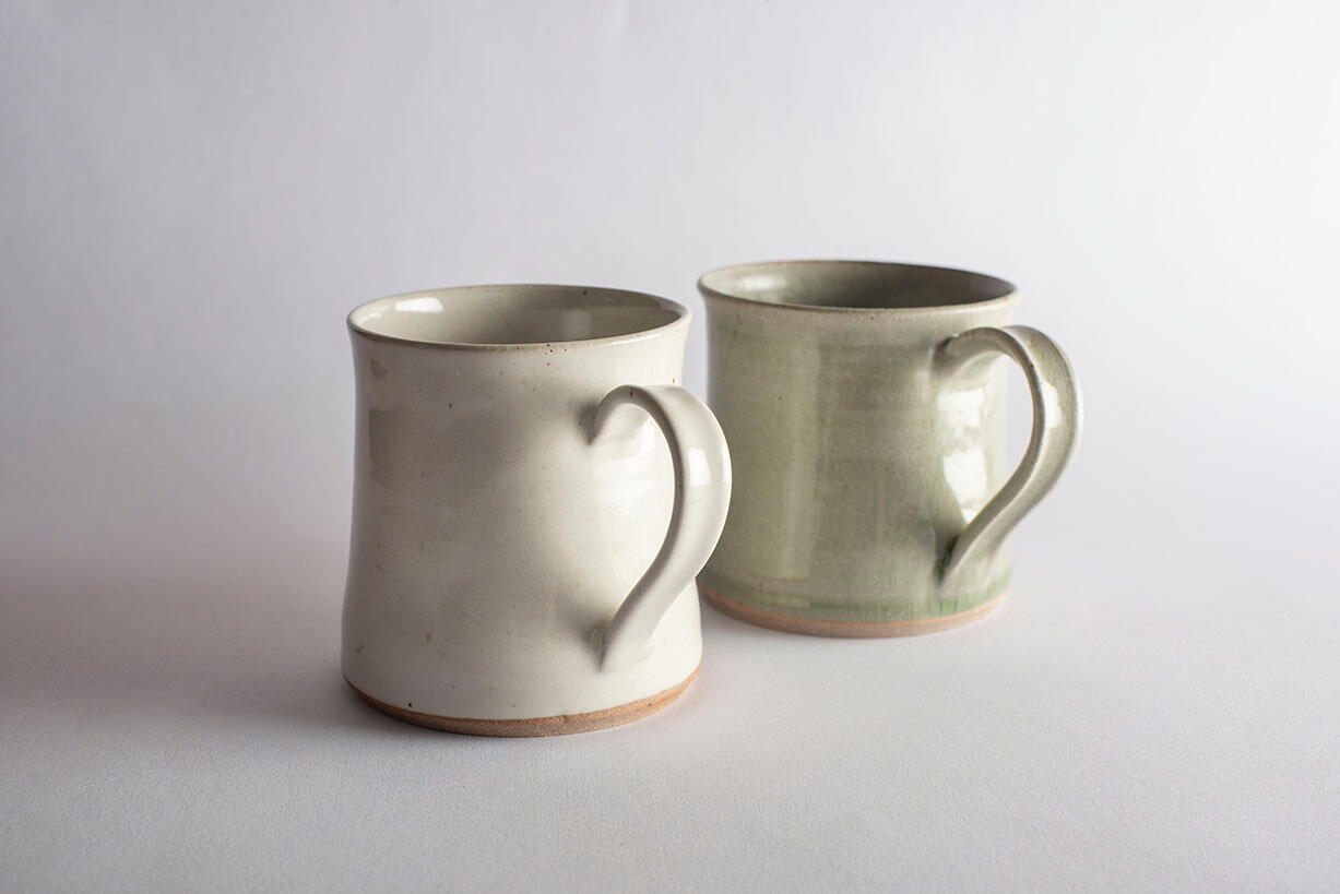 two grey glazed mugs