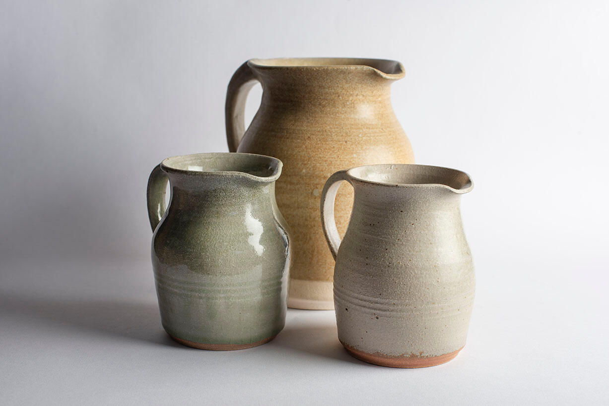 two grey glazed mugs