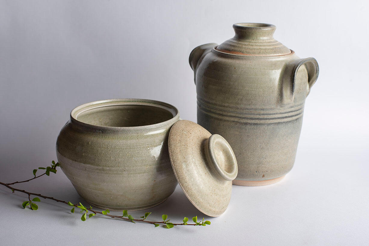 two grey glazed mugs